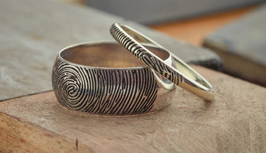 Fingerprint wedding rings on a jewellers bench