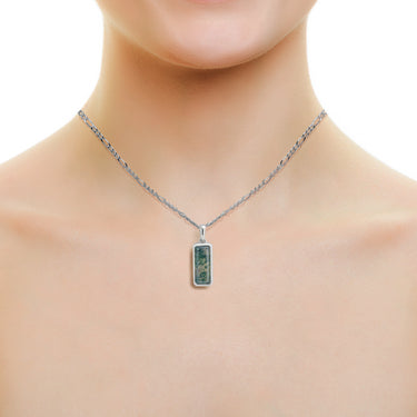 Moss agate silver necklace shown around neck
