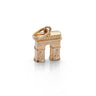 A small gold-toned charm shaped like the Arc de Triomphe, with a loop at the top, photographed on a clean white background.
