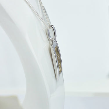 Side view of the silver rectangular ashes necklace