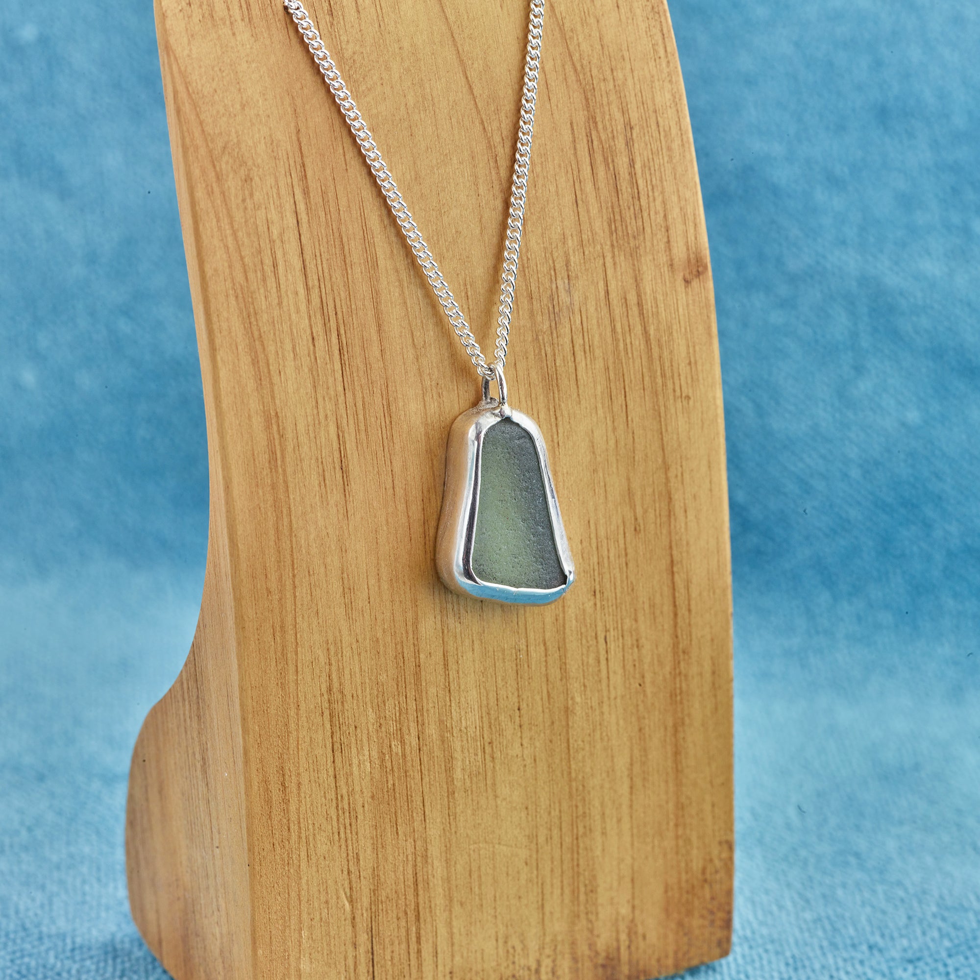 Showroom view of the green sea glass necklace with silver bezel setting