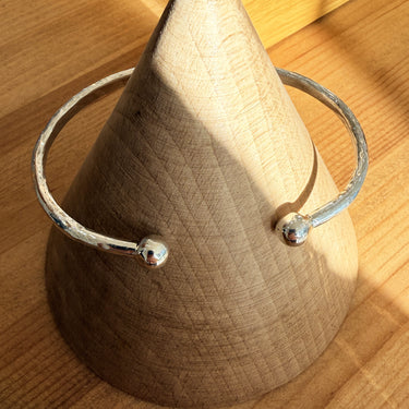 Handmade Recycled Silver Hammered Torque Bangle on Serendipity Diamonds showroom display cone