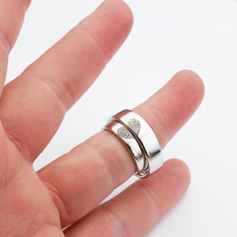 Heart fingerprint wedding ring set shown on finger