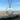 Isle of wight cutout necklace shown in front of Ryde beach on the Isle of Wight