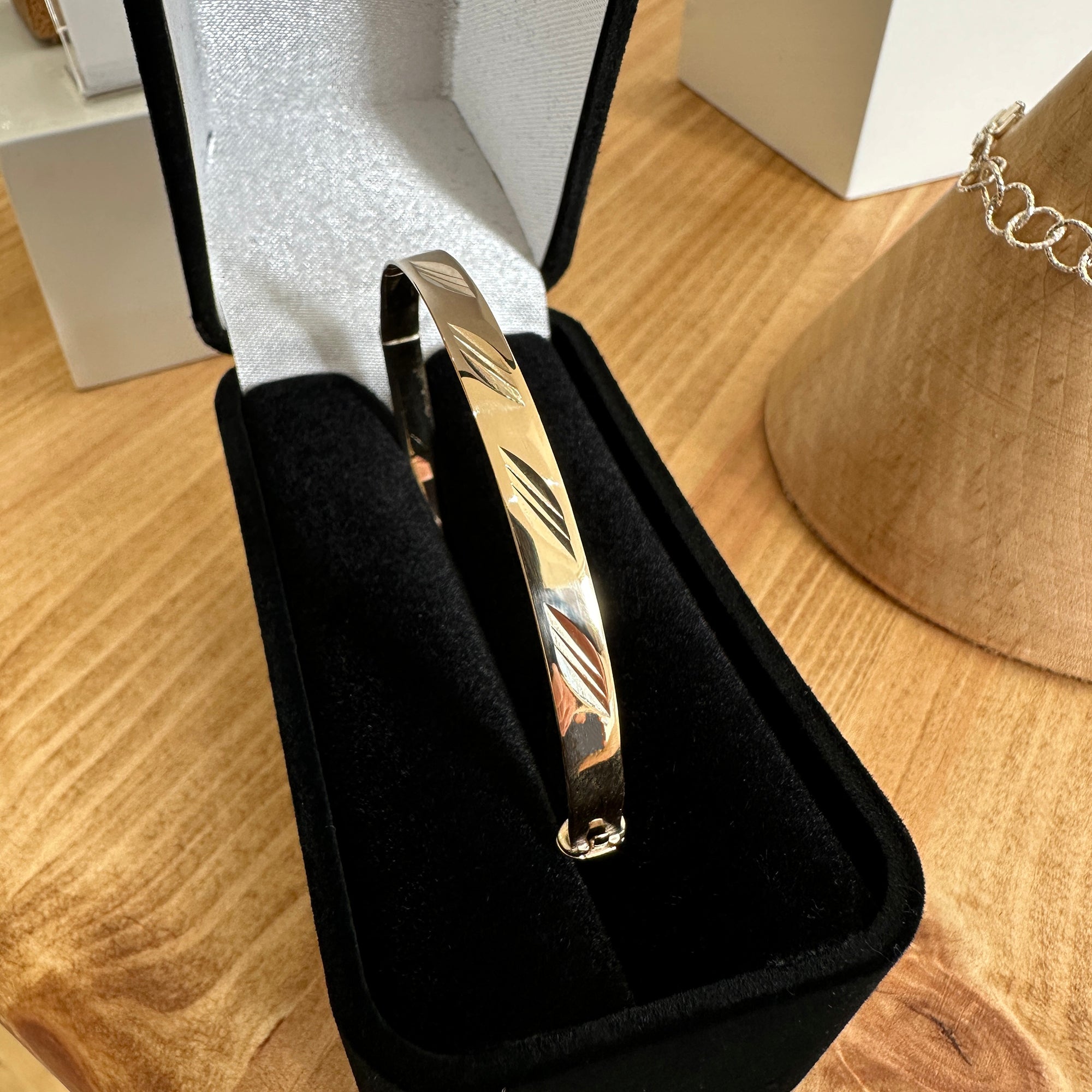 Pre-owned yellow gold bangle shown in presentation box