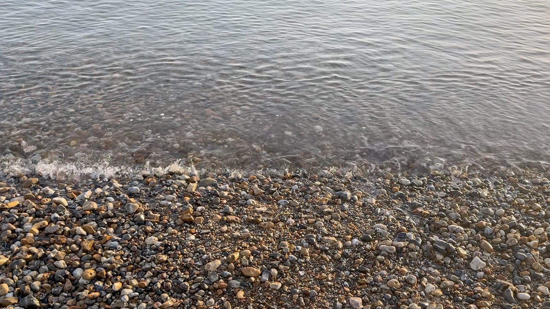 Pebbly beach with water at the edge