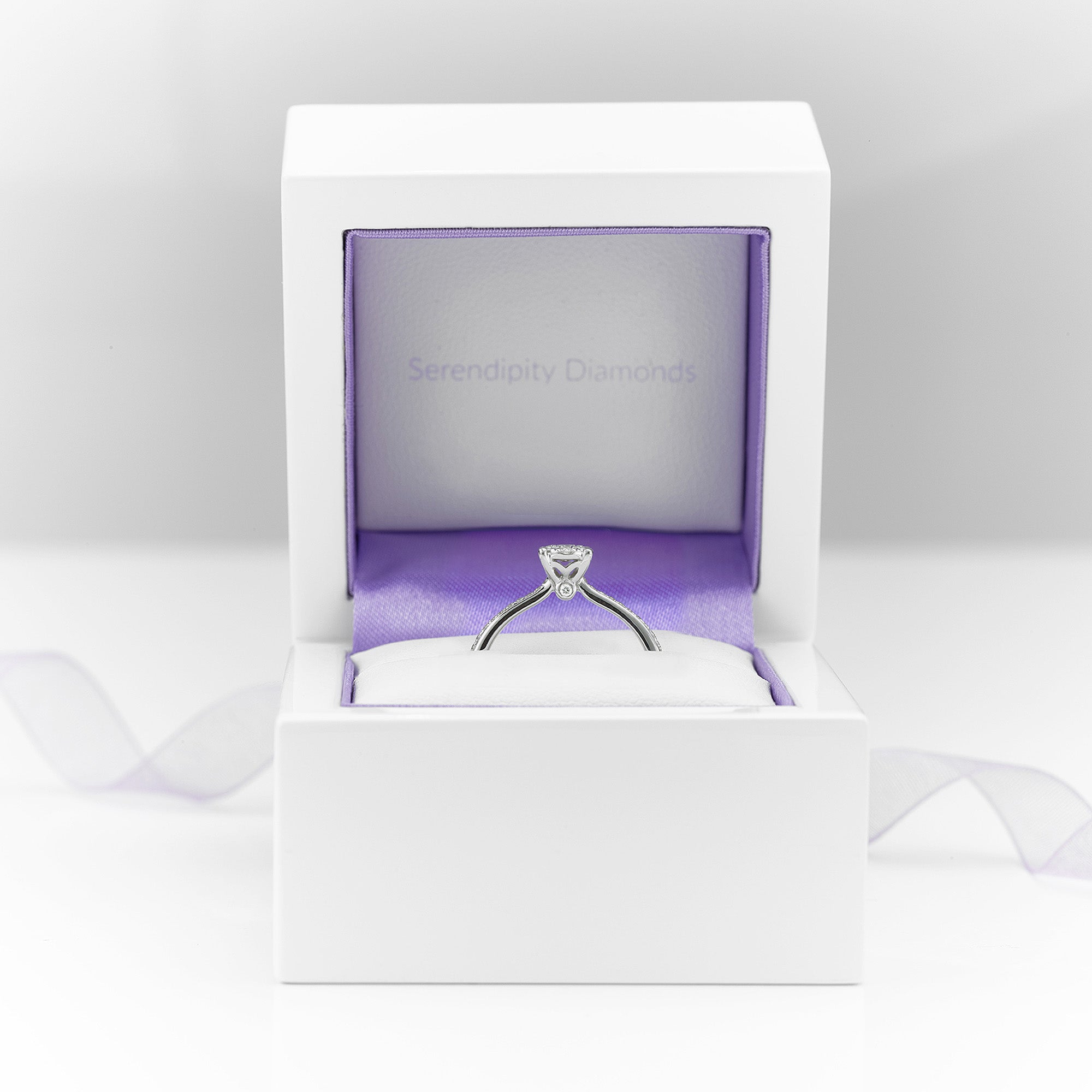 Illusion cluster engagement ring shown in ring box