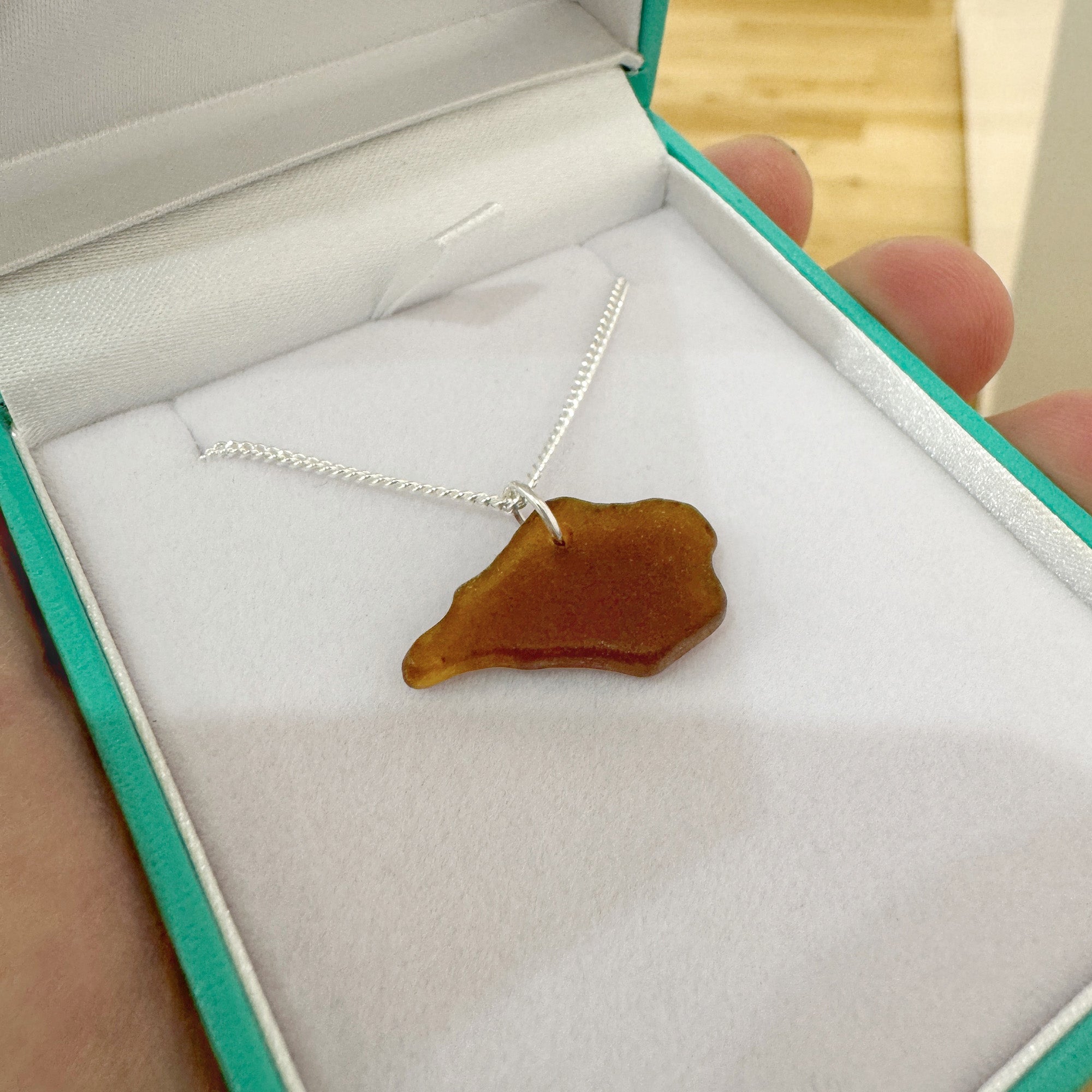 Small brown Isle of Wight sea glass necklace shown in presentation box.