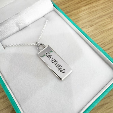 mini caulkhead necklace in box